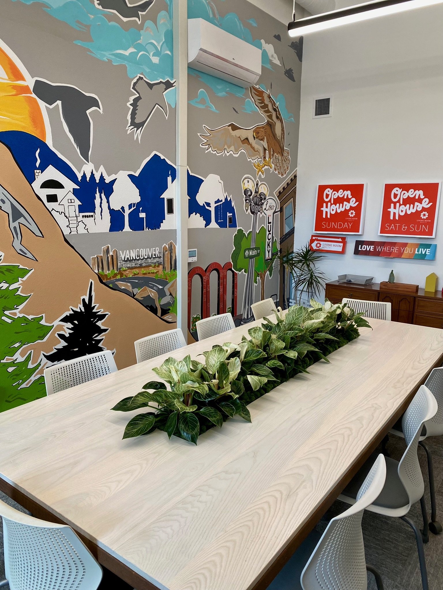 Conference room with colorful mural and plant centerpiece